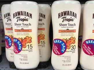 Bottles of Hawaiian Tropic sunscreen marked with Reef Safe stickers