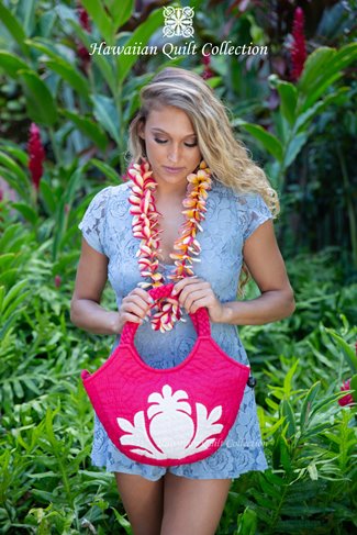 Woman wearing a lei and holding a pink quilted handbag.