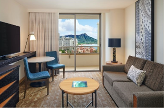Chic living area of a suite at Embassy Suites with a view of Diamond Head from the balcony.