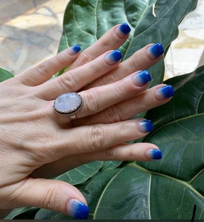 Two hands showing off a fresh blue gradient manicure by Hele Mai Salon.