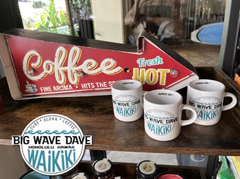 A vintage coffee sign with the words "Coffee Fine Aroma Hits the Spot" and an arrow pointing to "Fresh Hot" above a shelf displaying several white coffee mugs with "Big Wave Dave Waikiki" written on them, and a Big Wave Dave Honolulu, Hawaii Waikiki logo on the picture.