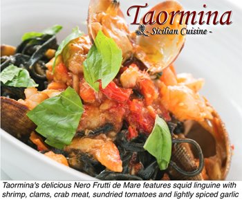 A plate of Nero Frutti de Mare consisting of squid linguine topped with shrimp, clams, crab meat, sundried tomatoes, and lightly spiced garlic.