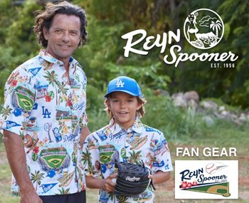 An adult and a child, both wearing patterned Reyn Spooner shirts and blue LA caps, stand outdoors holding a baseball glove. Text reads "REYN Spooner EST. 1956" and "FAN GEAR.