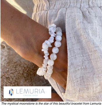 Hand wearing a white beaded bracelet from Lemuria Crystal Shop.