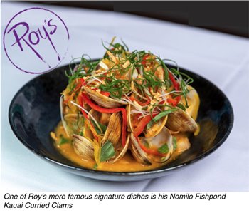 A bowl of Kauai Curried Clams from Roy's signature dish, Nomilo Fishpond, garnished with vegetables and served indoors.